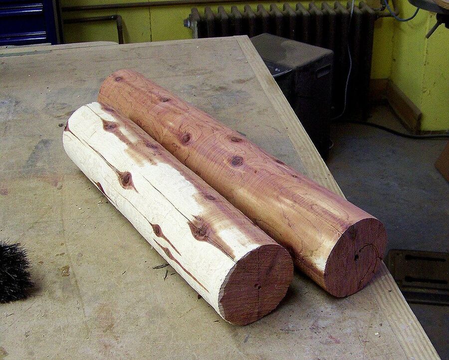 Sawn Eastern Redcedar log showing pale sapwood and pinkish-red aromatic heartwood